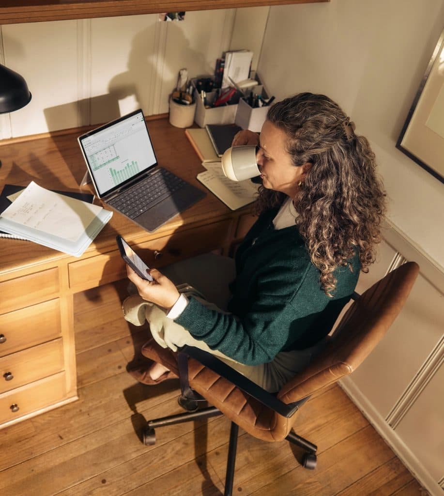 Small business owner reviewing financial reports at her desk