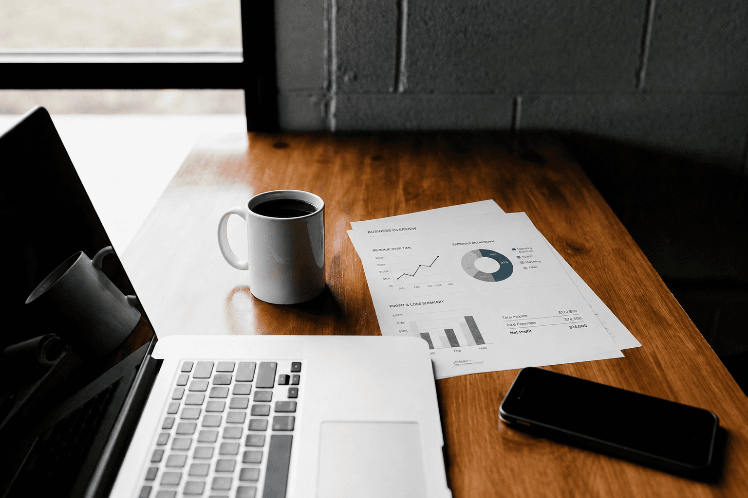 Bookkeeping desk with laptop and financial reports