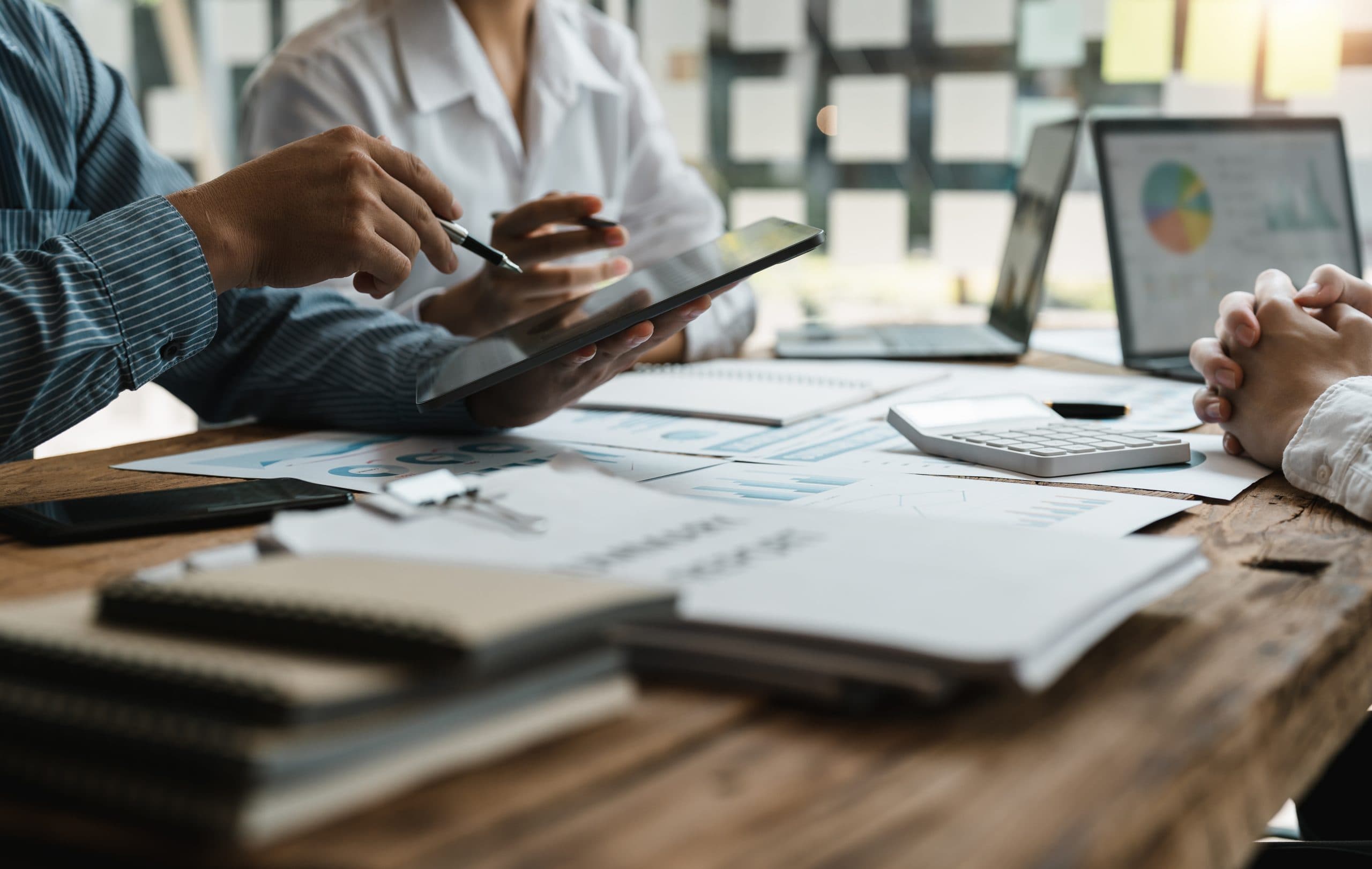 Business owners reviewing financial reports on a tablet